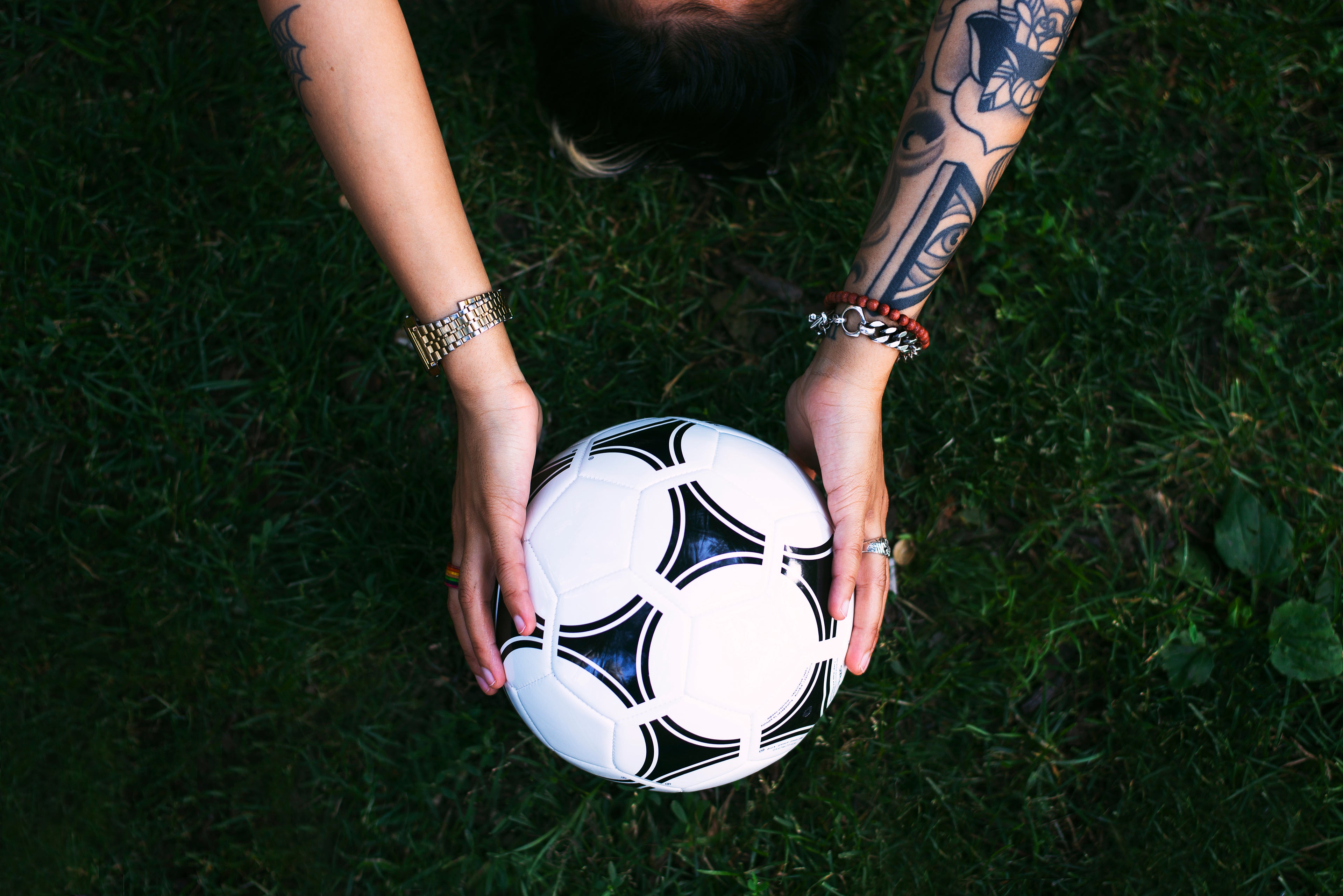 soccer-ball-in-hands-on-grass
